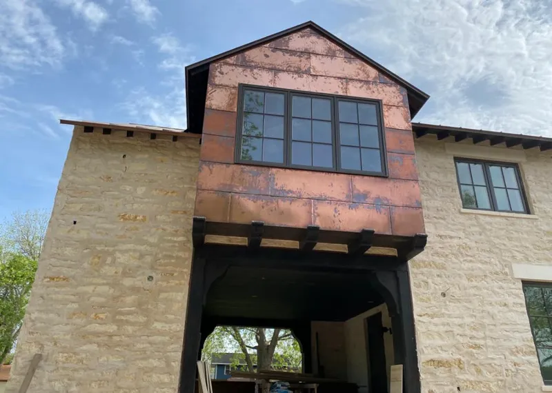 Copper metal panel facade on a stone building for Metal Roof Coating in Belterra