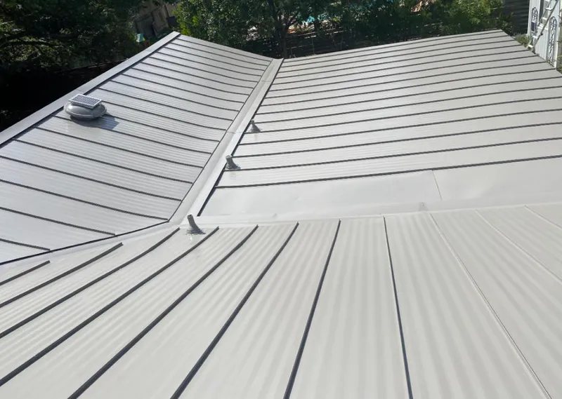 Solar attic fan installed on a metal roof for Roof Ventilation in Belterra
